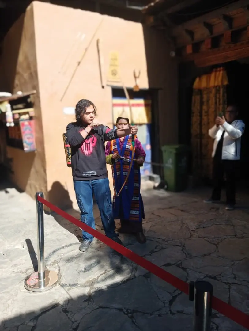 Tourist learning traditional Bhutanese archery